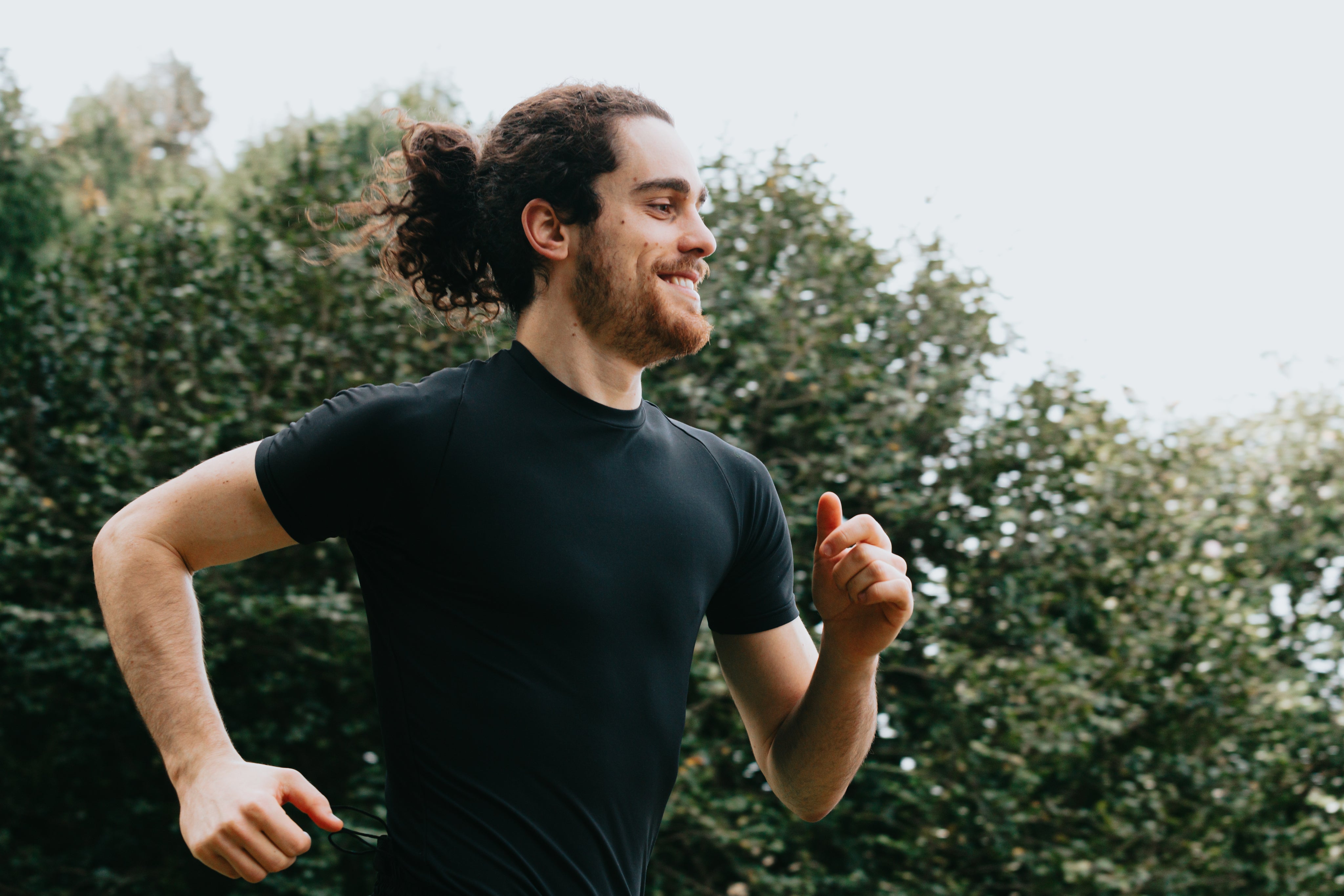 files/a-person-in-black-smiling-as-they-run-outdoors.jpg